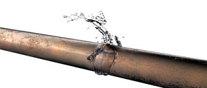 bigstock-Bursted-Copper-Pipe-With-Water-136974386