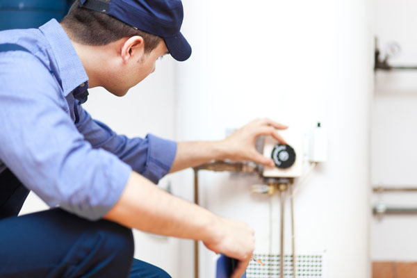 A plumber checking a hot water system.